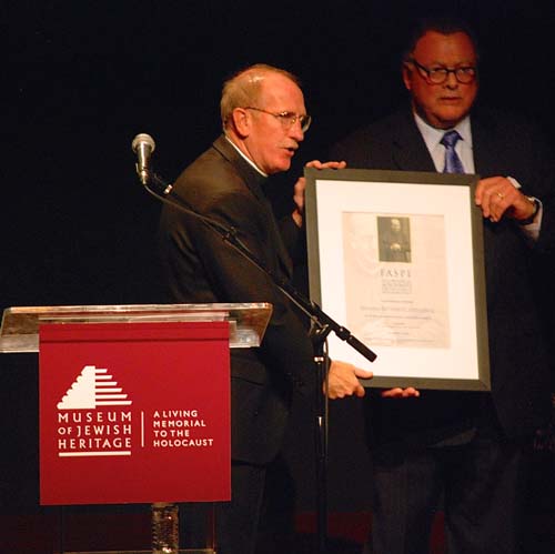 Reverend Joseph Michael McShane, S.J., President of Fordham University accepts the 2014 FASPE Award for Ethical Leadership on behalf of Blessed Bernhard Lichtenberg (posthumously) from Peter John Sacripanti, Chairman of McDermott Will & Emery LLP