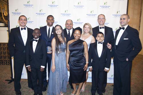 Big Brother Eric DeLillo; Little Brother Tamauri; Victor Cruz, 2012 Pro Bowl wide receiver for the New York Giants, Sidewalks of NY honoree; Little Sister Eliza; Hector Batista, Executive Director of Big Brothers Big Sisters of New York City; Big Sister Ayanna Kerrison; Tina Lundgren, philanthropist and Sidewalks of NY honoree; Little Brother Erik; Randy Milch, executive vice president of public policy and general counsel at Verizon, Sidewalks of NY honoree representing Verizon; and Big Brother Fernando Luciano at the 34th Annual Sidewalks of New York awards dinner, hosted by Big Brothers Big Sisters of NYC. Photo by: Thomas Donley