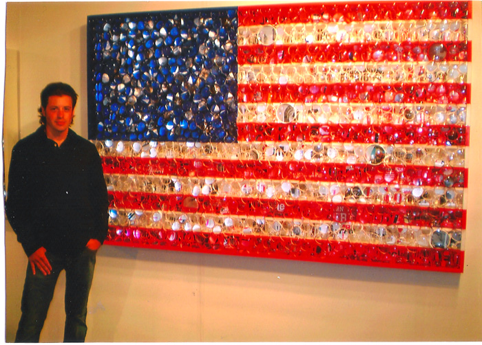 Dylan Reeve, young North Fork entrepreneur and art collector with artist David Datuna's "USA Viewpoints of Millions".