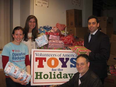 Africa Israel USA lends their support (and space at Manhattan’s Clock Tower Building) to Volunteers of America’s 2011 Christmas Toy Drive (from left: Kristin Kelly-Jangraw of Volunteers of America and Laurie Golub, Damien Stein and Ilya Braz of