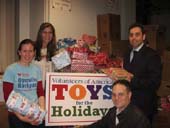 Africa Israel USA lends their support (and space at Manhattan’s Clock Tower Building) to Volunteers of America’s 2011 Christmas Toy Drive (from left: Kristin Kelly-Jangraw of Volunteers of America and Laurie Golub, Damien Stein and Ilya Braz of