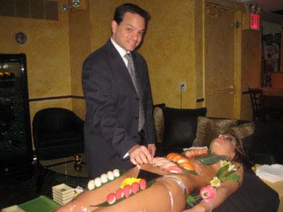 05-04-12 General Manager Shawn R. Callahan tastes the "body sushi" on dancer Adriana at a press conference at the former Charlie Sheen VIP Room at Cheetah's Gentlemen's Club. 252 West 43rd St. Thursday night 05-03-12