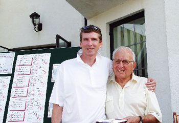  Greenwich resident Tom Hughes, chairman of Kings Point Capital Management and a member of the Merrill Lynch team, won the Closest to the Pin challenge at Stamford Hospital s Corporate Invitational. Greenwich resident Carl Bennett, co-chair of the annual golf event, congratulates Hughes on the achievement. Photo by:Andy King -Foursomephotos