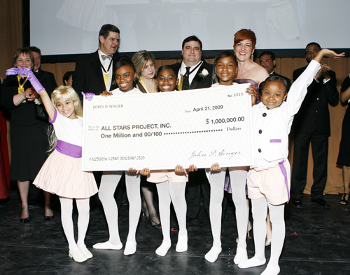 John and Madlyn singer, Art Advisors, LLC (second row 3rd and 4th from left) presented $1,000,000 check to youth of the All Stars Project at 2009 gala benefit at Lincoln Center.  All Stars Project president and CEO, Gabrielle L. Kurlander (second row, 5th from left) with All Stars Project Hall of Fame Honorees, Lynee Turley (second row, left), Edward C. Malmstrom, Bank of America Securities/Merrill Lynch & Co., (back row, partially obscured) and James Turley (second row, second from left), Chairman and CEO of Ernst and Young looking on