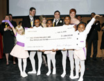 John and Madlyn singer, Art Advisors, LLC (second row 3rd and 4th from left) presented $1,000,000 check to youth of the All Stars Project at 2009 gala benefit at Lincoln Center. All Stars Project president and CEO, Gabrielle L. Kurlander (second row, 5th from left) with All Stars Project Hall of Fame Honorees, Lynee Turley (second row, left), Edward C. Malmstrom, Bank of America Securities/Merrill Lynch & Co., (back row, partially obscured) and James Turley (second row, second from left), Chairman and CEO of Ernst and Young looking on