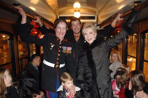 USMC Cpl. Aaron Mankin, Travis Coursey and Patricia Kennedy on the vintage trolley that carried guest from the Auditorium Theatre to the Palmer House for the Joffrey Nutcracker Family Dinner.