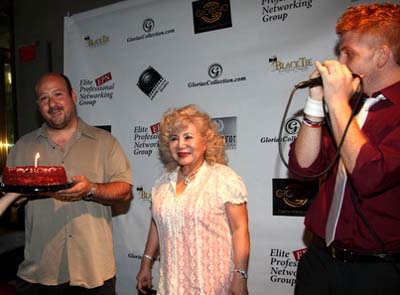 Barry Brown with his birthday cake with Gloria and singer Dan Godlin