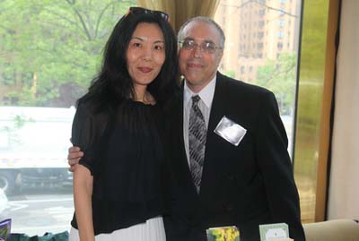 Dr. Hong Zhang of Double Diamond Wells and Sam Liebowitz of Talking Alternative Broadcating with there sponsorship table.