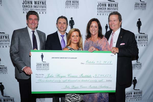 The Auxiliary presented an oversized check for $798,178 from funds raised in the last year by the Auxiliary and earmarked for JWCI.  Pictured (L-R) Marcel Loh (Chief Executive JWCI & Providence Saint Johns Health Center), Dr. Anton Bilchik (Chief of Medicine, JWCI), Melanie Wayne (daughter of John Wayne), Anita Swift (JWCI Auxiliary President and granddaughter of John Wayne) and Patrick Wayne (JWCI Chairman and son of John Wayne) Photo by:  Vince Bucci