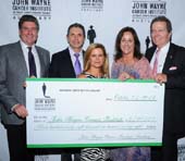 The Auxiliary presented an oversized check for $798,178 from funds raised in the last year by the Auxiliary and earmarked for JWCI. Pictured (L-R) Marcel Loh (Chief Executive JWCI & Providence Saint John’s Health Center), Dr. Anton Bilchik (Chief of Medicine, JWCI), Melanie Wayne (daughter of John Wayne), Anita Swift (JWCI Auxiliary President and granddaughter of John Wayne) and Patrick Wayne (JWCI Chairman