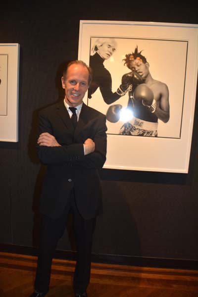 Michael Halsband Photographer extraordinaire at The NAC opening reception (Background image - Warhol Basquait).  Photo by:  Rose Billings/Blacktiemagazine.com