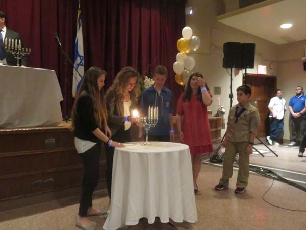The friends of Ezra Schwartz, the 18 year old American who was killed near the Gush Etzion region in Israel on the afternoon of November 19.light candles in his memory. Photo by: Joyce Brooks/Blacktiemagazine.com