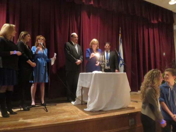 Lt. Governor Kim Guadagno Lights the candle.... Photo by: Joyce Brooks/Blacktiemagazine.com
