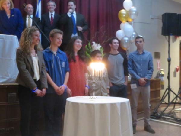 The friends of Ezra Schwartz, the 18 year old American who was killed near the Gush Etzion region in Israel on the afternoon of November 19.light candles in his memory. Photo by: Joyce Brooks/Blacktiemagazine.com