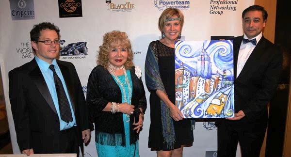  Diane McGraw of McGraw Productions Accepting painting from artist Juan Fernando Silva