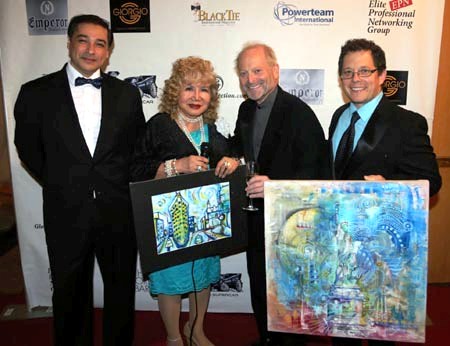 Sandy Jacolow receiving his paintings from artist Michael Indorato and Juan Fernando Silva