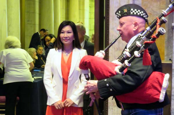 Mei Hing Chak, being piped into the Medal Awards Ceremony by Jim Brady,