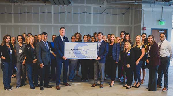 Jeff and Jennifer Gross present a $5 million donation to members of the CHOC Foundation and CHOC's neonatal intensive care unit. Photo courtesy of CHOC Children's