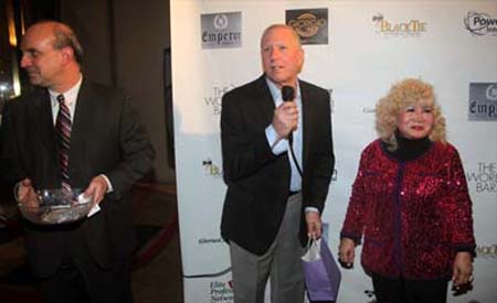Nick Alessi of AR-1Supercar giving a door prize to Carla Jeminez