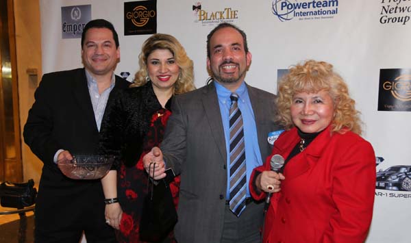 Robert Feliciano receiving his door prize from Yelena Kalendareva President/CEO Aneley cosmetics.