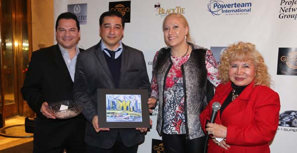    Xemina Hidalgo Ayala receiving her door prize from artist Fernando