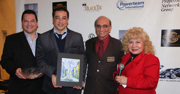    Xemina Hidalgo Ayala receiving her door prize from artist Fernando