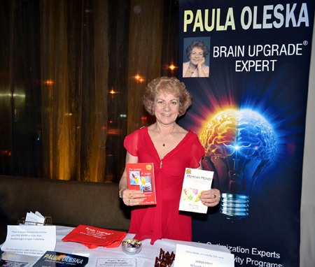 Paula Oleska President of Brain Upgrade in her sponsorship table