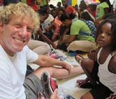 (Billy4Kids Founder and iPark CEO Billy Lerner helping fit shoes on children)