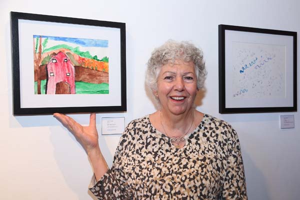 MiM artist Jane Stang pictured with Janes artwork entitled My Farm House